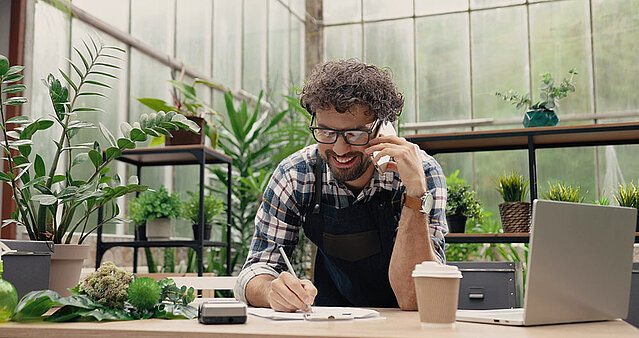 Glücklicher Florist lässt sich von FirmenABC zum Firmenbuchauzug beraten.